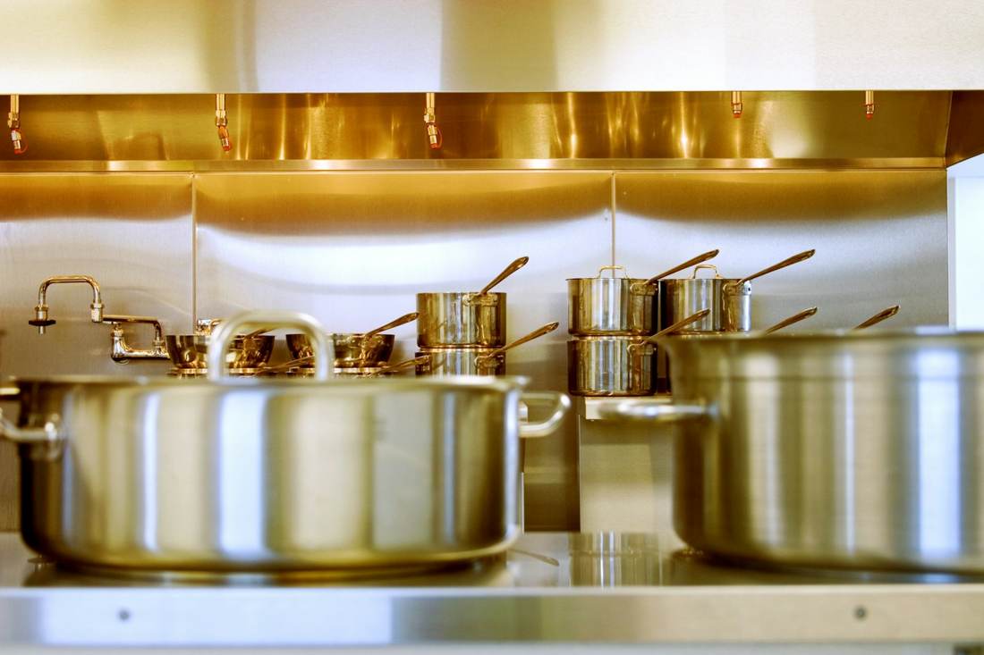 Stainless steel pots on a kitchen counter